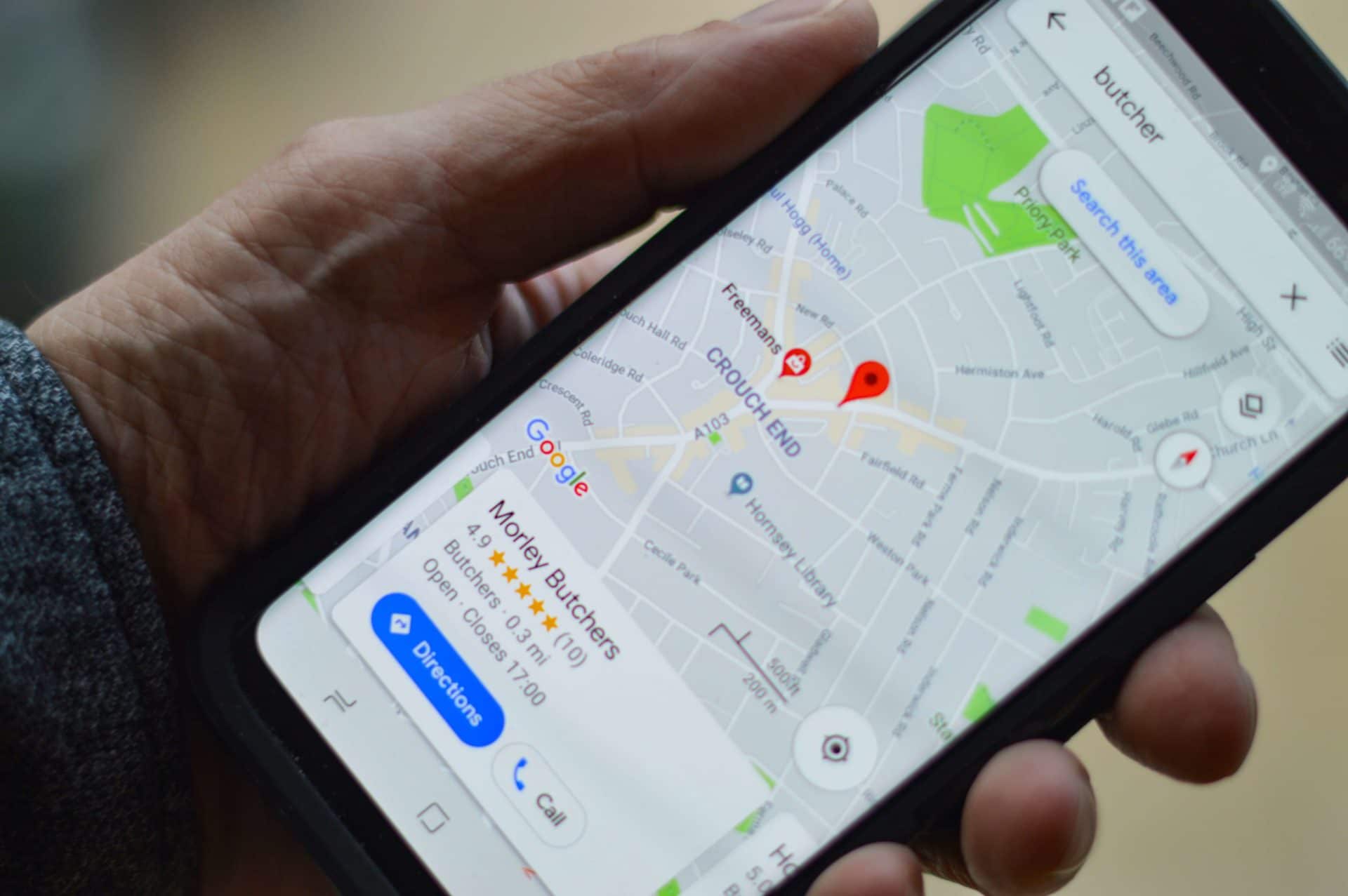 hand holding a phone with Google maps
