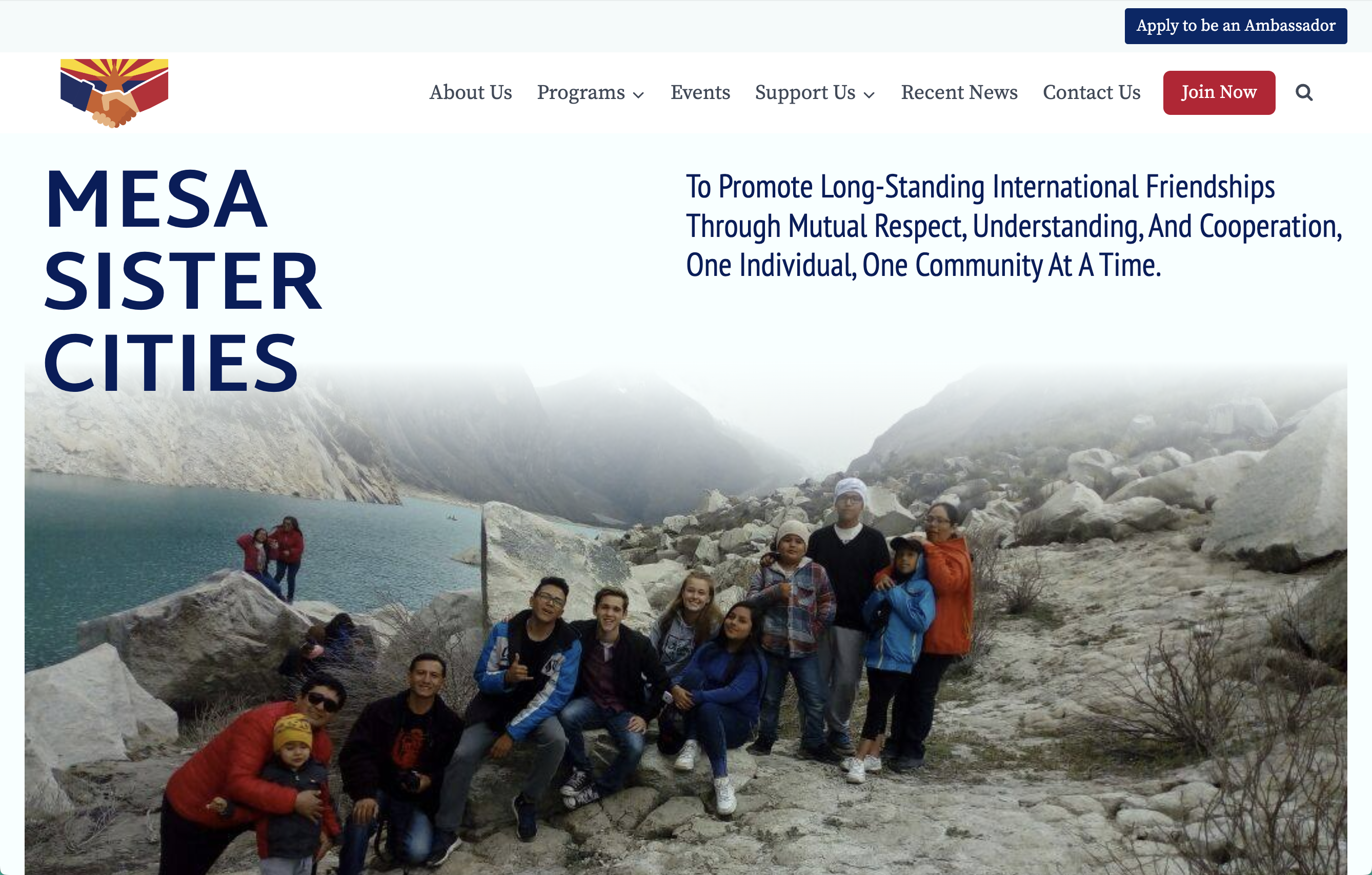 Screenshot of the home page of Mesa Sister Cities with a group of Student exchange ambassadorsby a river in Caraz Peru.